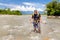 Tough man crossing jungle river stream Quincemil, Peru travel.