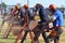 Tough men demonstrating chainsawing logs at country fair