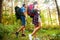 Tough route. Beautiful young couple hiking together in the woods while enjoying their journey.