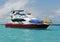 Tour Boat anchored in shallow ocean shoreline Santa Fe Island in the Galapagos, Ecuador.