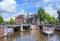 Tour boat with tourists on a canal, Amsterdam, Netherlands