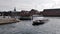 Tour boat which full of tourists move into Frederiksholms canal and background of waterfront and Det Kongelige library.