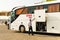 Tour busses with guides waiting for tourists