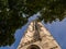 Tour Saint Jacques behind summer foliage; blue sky in background