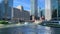 Tourboat and water taxi pass each other while tourists paddle kayaks during evening commute on Chicago River.