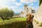 Tourism in Italy. Back view of beautiful girl enjoying view of the Basilica of Saint Francis of Assisi in Umbria, Italy