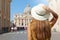 Tourism in Italy. Back view of young tourist woman walks along Via della Conciliazione street in Rome with St Peter Basilica and