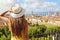 Tourism in Italy. Back view of young woman holding her hat with Florence city on the background, Tuscany, Italy