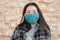 Tourism and travel in times of covid19 - young happy and beautiful Asian Korean woman in surgical mask vs covid  enjoying city