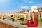 Tourism in Tuscany. Rear view of young fashion woman sitting and looking at Ponte Vecchio bridge in Florence, Italy