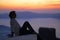 A tourist admires the sunset at Imerovigli, Santorini