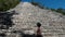 Tourist admiring the mayan attraction of the pyramid of coba, belonging to the ancient mayan civilization that expanded along the