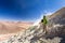 Tourist adventurer backpacker standing smoking volcano mountain