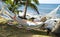 Tourist asleep in hammock by the caribbean sea