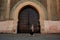 Tourist by authentic gate in Meknes, Morocco