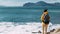 Tourist with a backpack against the sea, panorama. Portrait of a woman in tourist gear against the sea. Travel