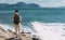 Tourist with a backpack against the sea, panorama. Portrait of a woman in tourist gear against the sea. Travel