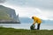 Tourist with backpack in yellow jacket at Witches Finger cliffs