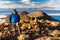 Tourist backpacker standing mountain huge cactus, Salar De Uyuni, Bolivia.