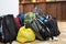 Tourist backpacks stand on the floor indoors.