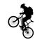 Tourist on a bike. Logo, emblem for a tourism club. Black silhouette of a man with a backpack on a bicycle on a white background