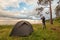 Tourist with binoculars near camp tent