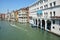 Tourist blond curly woman on the Piazza San Marco near Grand Chanal in Venice