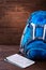 Tourist blue big backpack and map against wooden background.