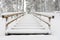 Tourist boardwalk with foot tracks on winter road