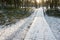 Tourist boardwalk with foot tracks on winter road