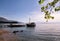 Tourist boat cruiser in small marina on sea and beautiful beach, waiting tourists for ship is sailing out of port for tourist tour