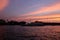 A tourist boat floats on the Chao Phraya river at sunset. Romantic sunset over Bangkok