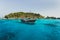 Tourist boat near island shore with turquoise clear transparent water
