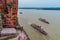 Tourist boat with passengers sailing on the Min and Dadu river below the giant Buddha statue in Leshan