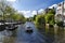 Tourist boat sailing in the canals of Amsterdam Holland