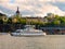 Tourist boat sailing on the lake on the background of beautiful buildings of Stockholm