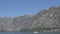 Tourist boat sails along the Bay of Kotor against the backdrop of picturesque mountains