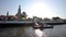 A tourist boat swims past a beautiful pagoda in sunny weather