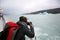 Tourist on boat taking photo of an Iceberg in Argentina