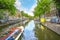 A tourist boat travels a picturesque canal in Amsterdam