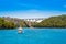 Tourist boats and Sibenik bridge over Krka River in Krka National Park, Croatia. River and two mountains on a sunny day