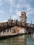 Tourist on the bridge taking photo with their smart phone at the Arsenal Entrance in Venice