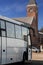 The tourist bus against the background of an ancient tower in the city of Vyborg