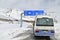 Tourist Bus and Destination Sign at Khunjerab Pass Between Pakistan-China Border