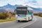 Tourist bus moves along mountain road