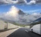 Tourist bus rushes along the country high-speed highway against the background of a mountain landscape.