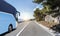 Tourist bus rushes along the country high-speed highway against the background of a mountain landscape.