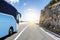 Tourist bus rushes along the country high-speed highway against the background of a mountain landscape.