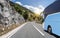 Tourist bus rushes along the country high-speed highway against the background of a mountain landscape.