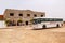 Tourist bus stopped near a souvenir shop and cafe in the Sahara desert, Tunisia